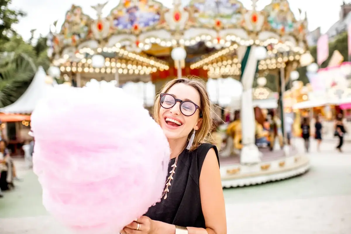 woman-with-cotton-candy-at-the-amusement-park