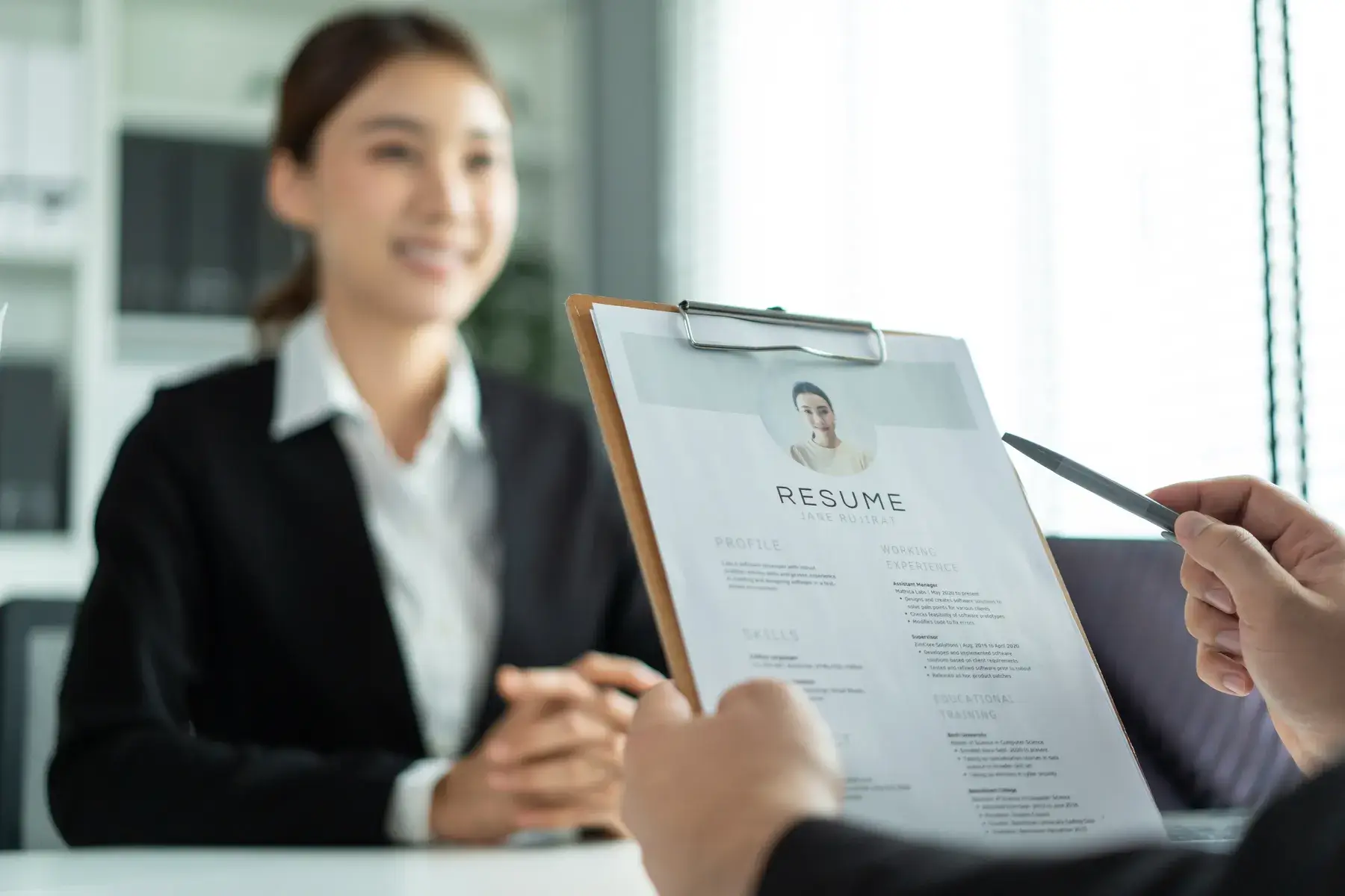 close-up-of-woman-give-resume