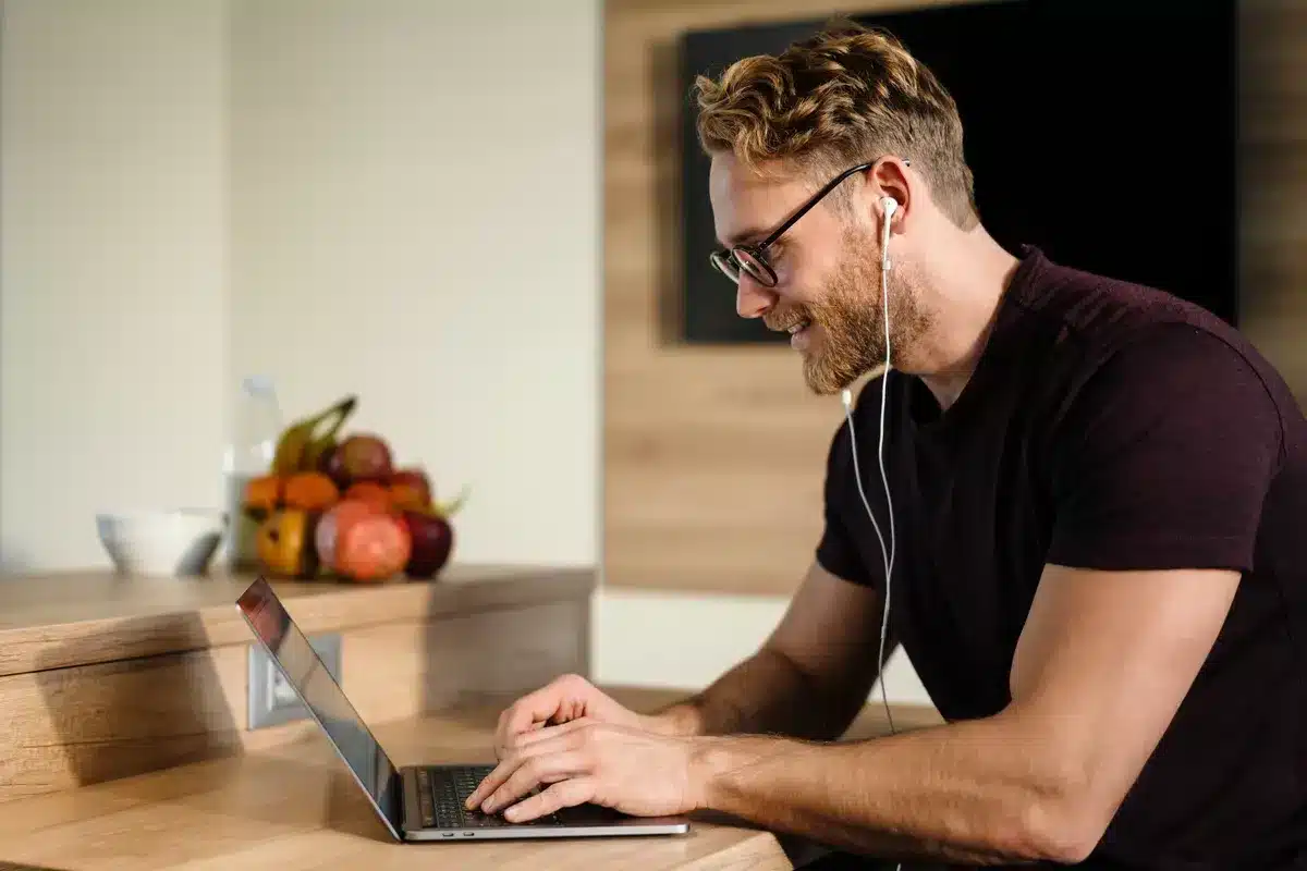 young-man-working-remotely-and-heaving-a-meeting