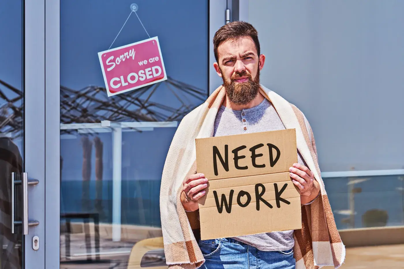 unemployed-man-with-signboard-need