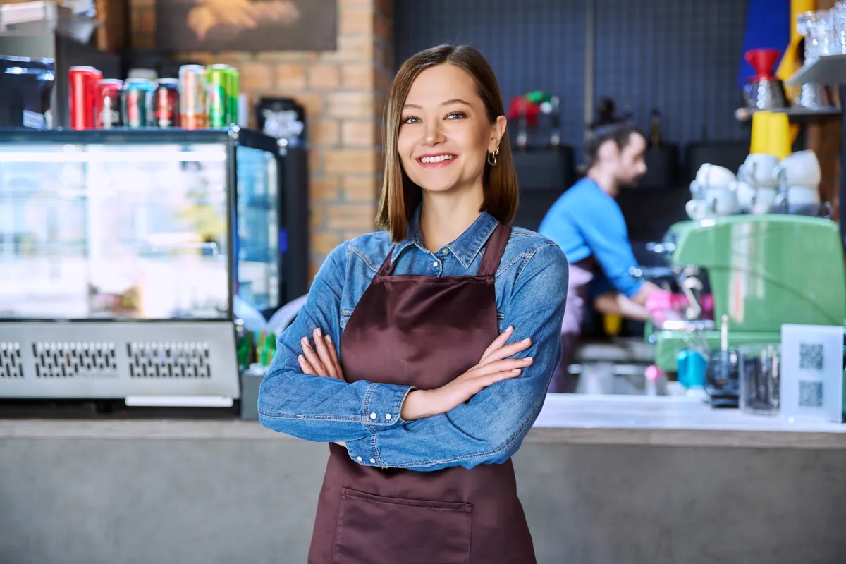 young-woman-service-worker-in-apron-looking