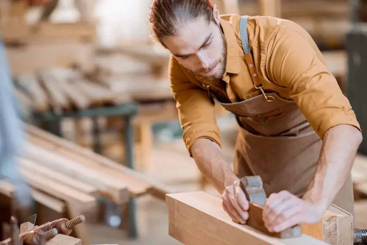 carpenter-working-with-a-wood.webp