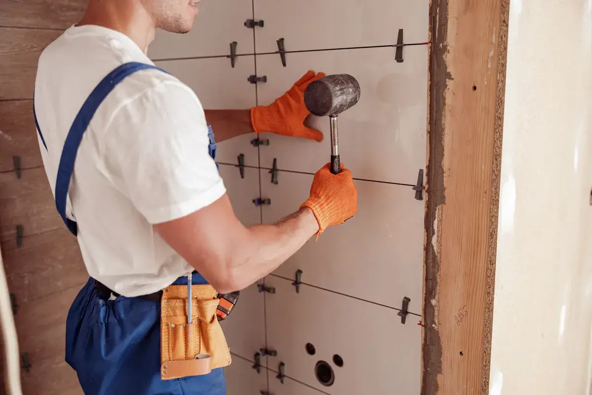 male-worker-installing-ceramic-wall-tile