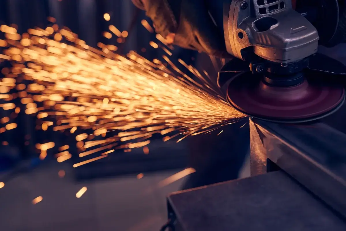 worker-cutting-metal-with-grinder-sparks