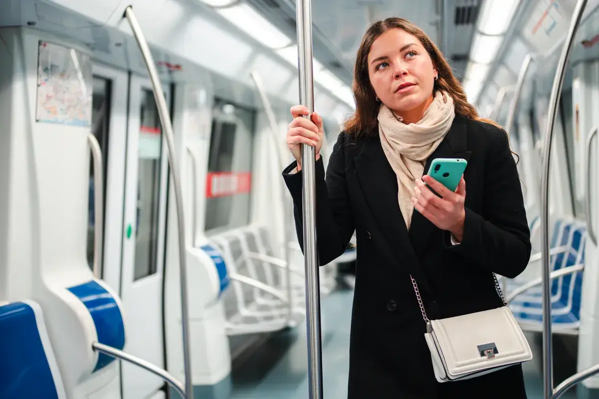 thoughtful-young-woman-standing-in-a-subway-.webp