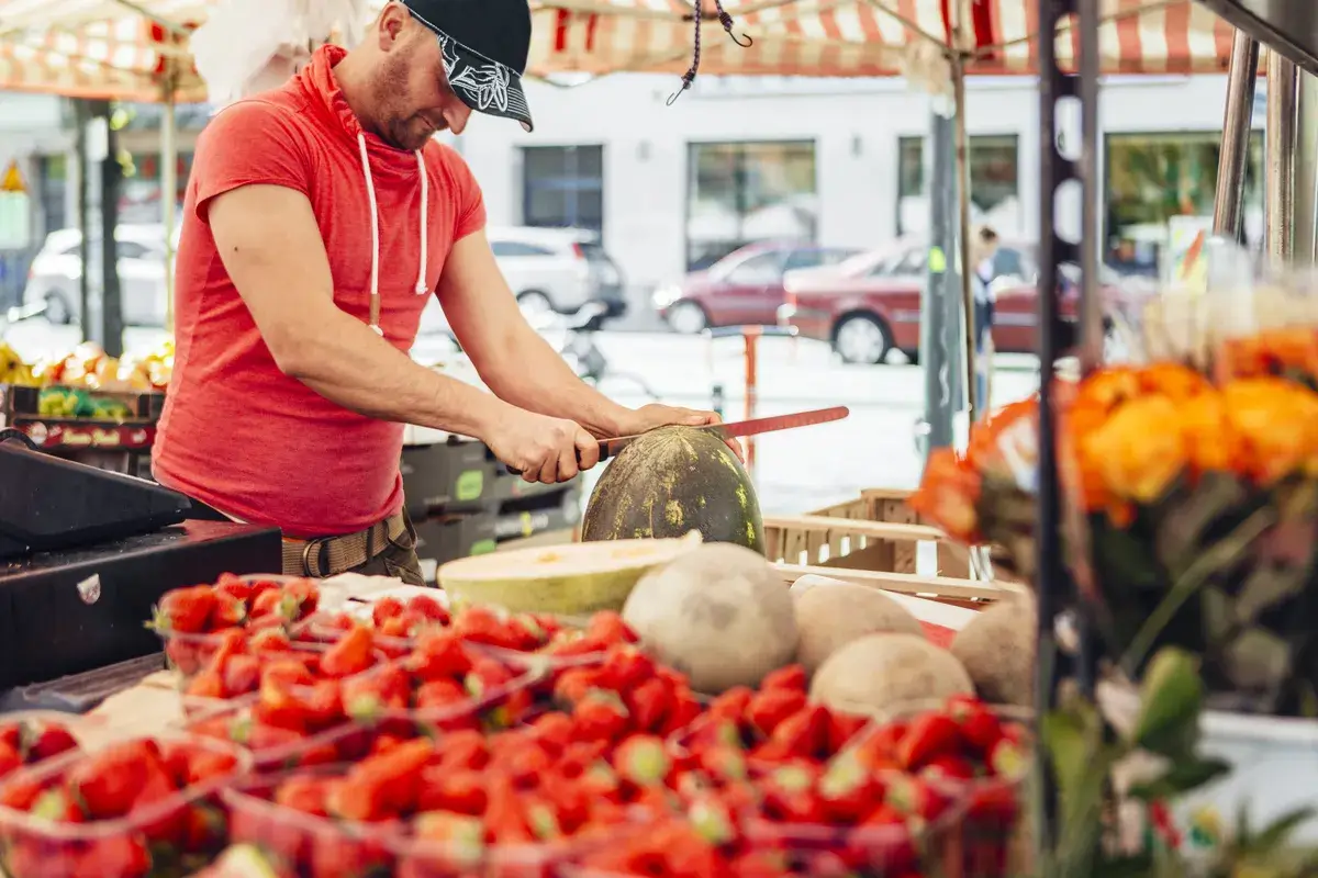 vendor-cutting-watermelon-at-fruit-stall