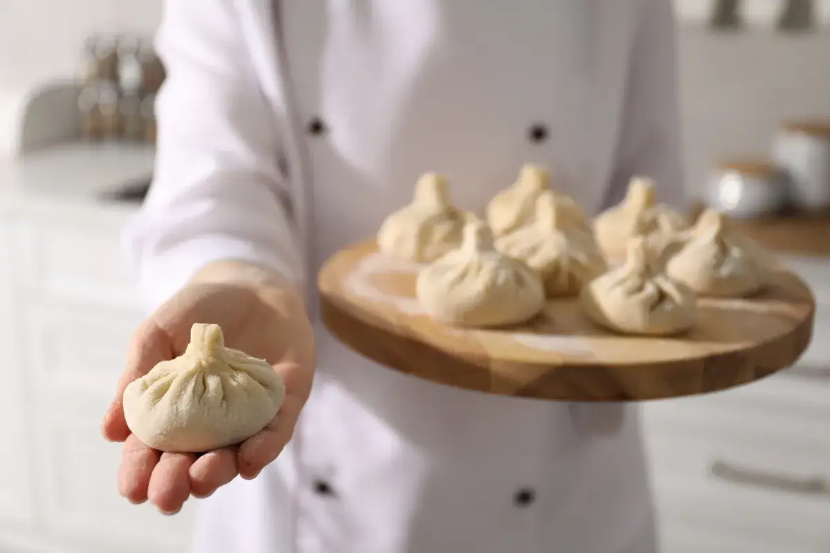 chef-holding-board-with-uncooked