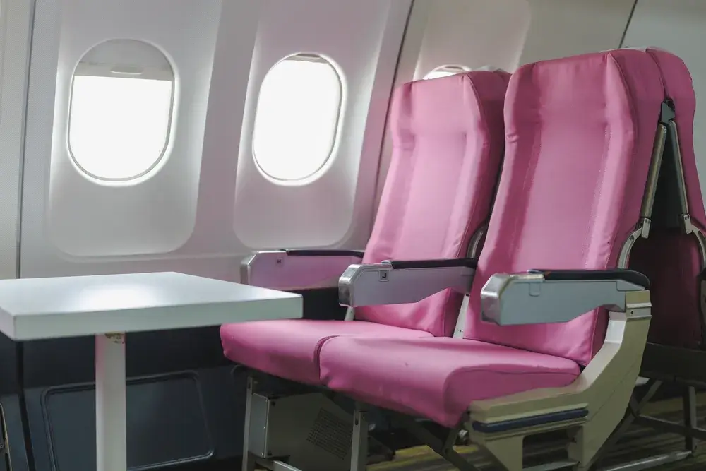 empty-pink-airplane-seats-by-the-window
