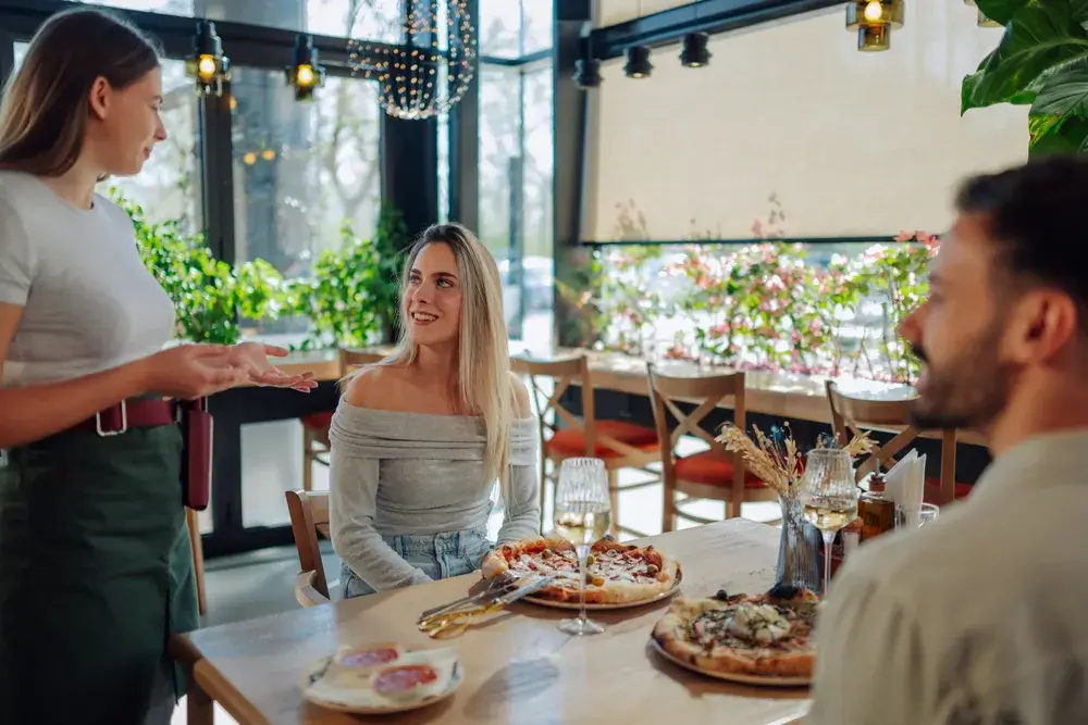 waitress-suggesting-pizza-to-couple