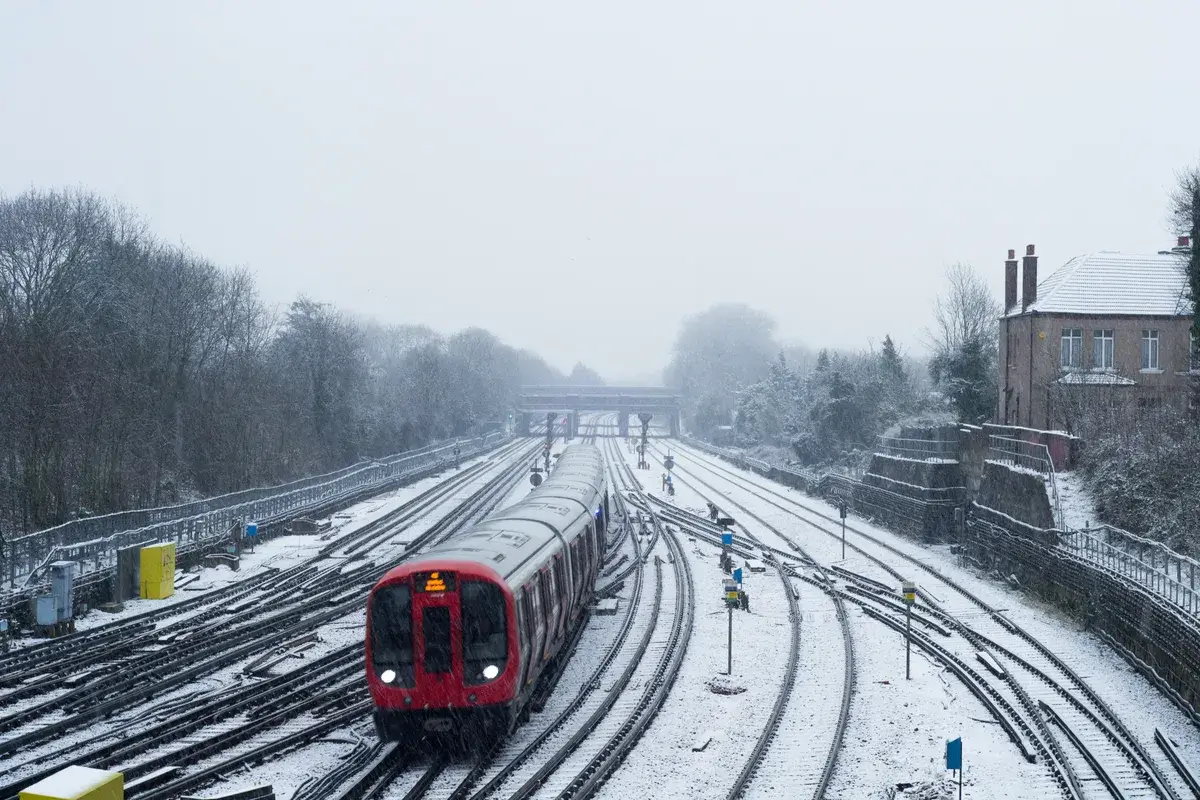 red-train-during-winter-covered