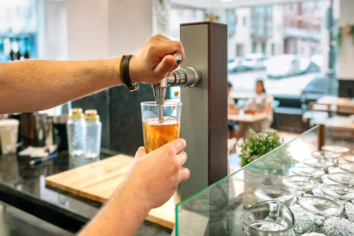 unrecognizable-bartender-pouring-beer