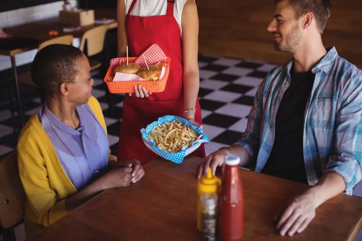 waitress-serving-burger-and-french