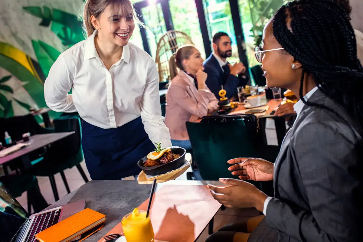 smiling-waitress-serving-meal