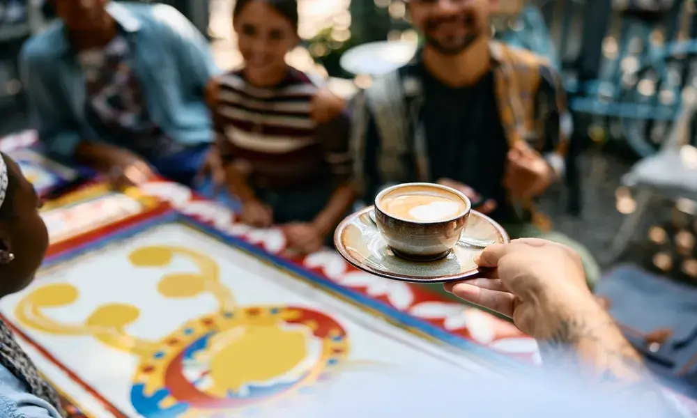 close-up-of-waiter-serving-coffee