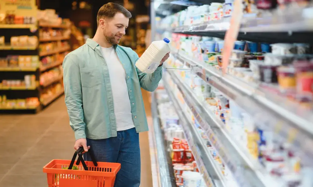 customer-choosing-milk-bottle-in-supermarket