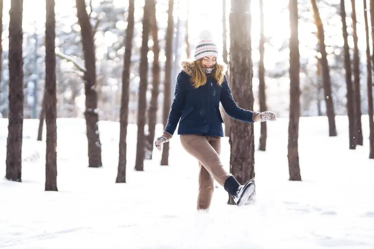 happy-woman-plays-with-snow-in-sunny-winter