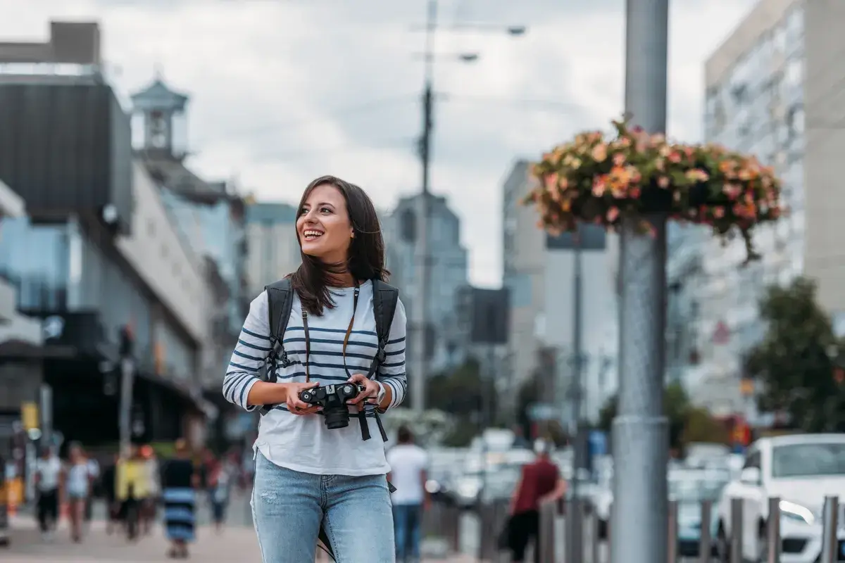 smiling-woman-with-digital-camera-looking