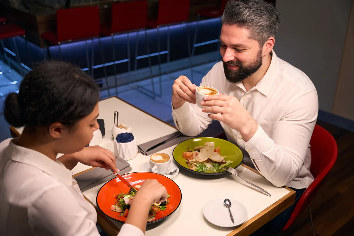 cheerful-young-man-having-dinner-with