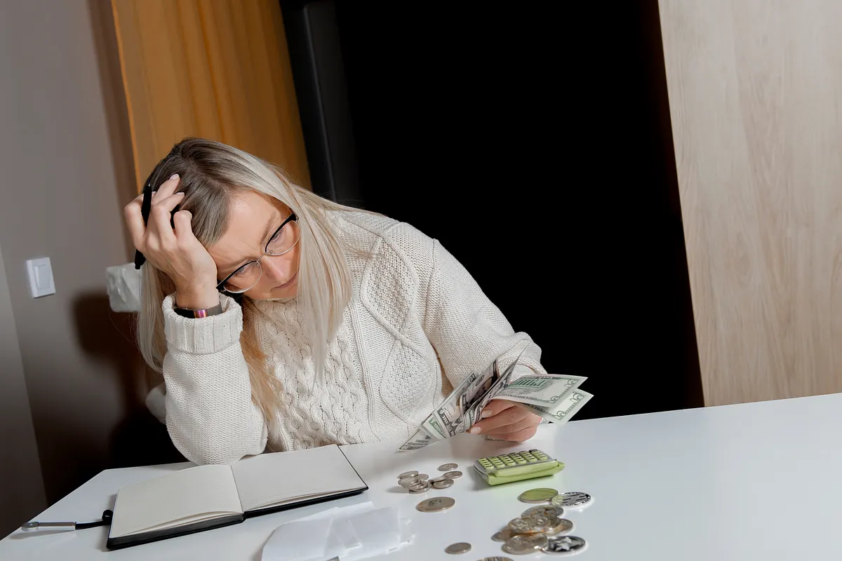 desperate-woman-holds-money-dollar
