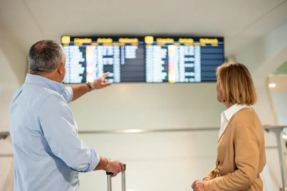 senior-couple-checking-flight-information