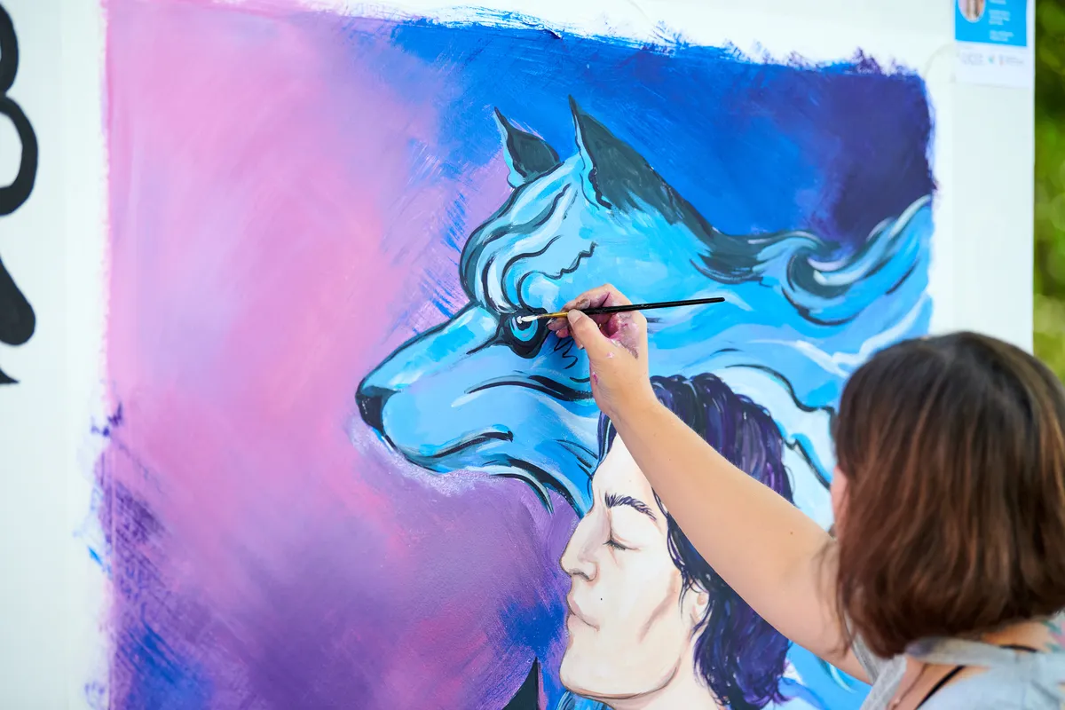 woman-artist-hand-holds-paint-brush