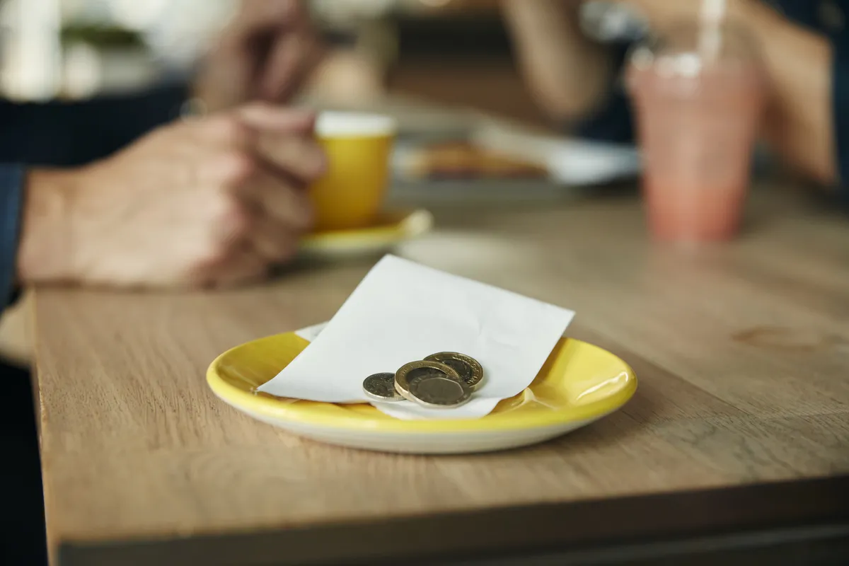 a-small-saucer-with-a-till-receipt
