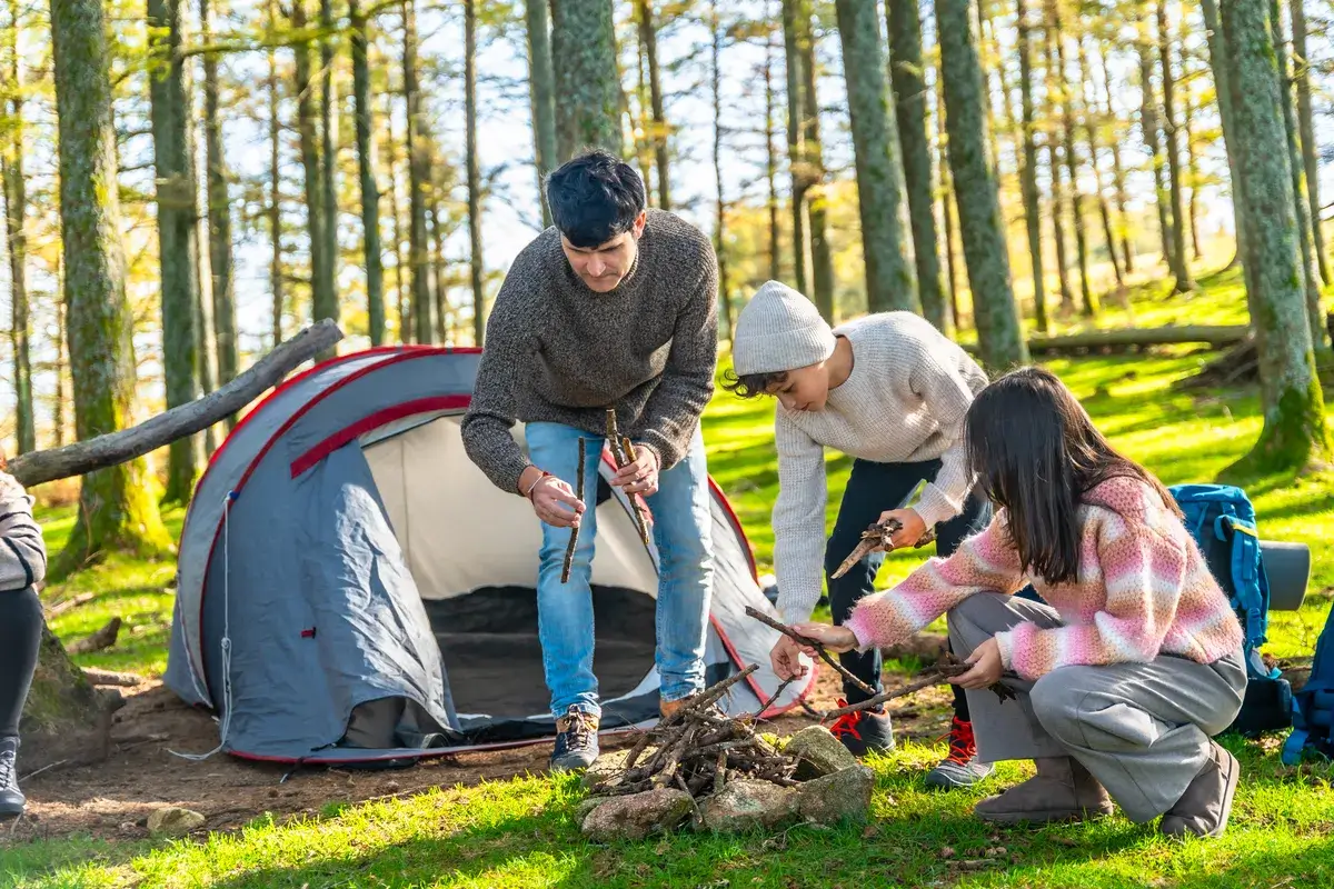 father-and-sons-making-a-bonfire-in-the-forest