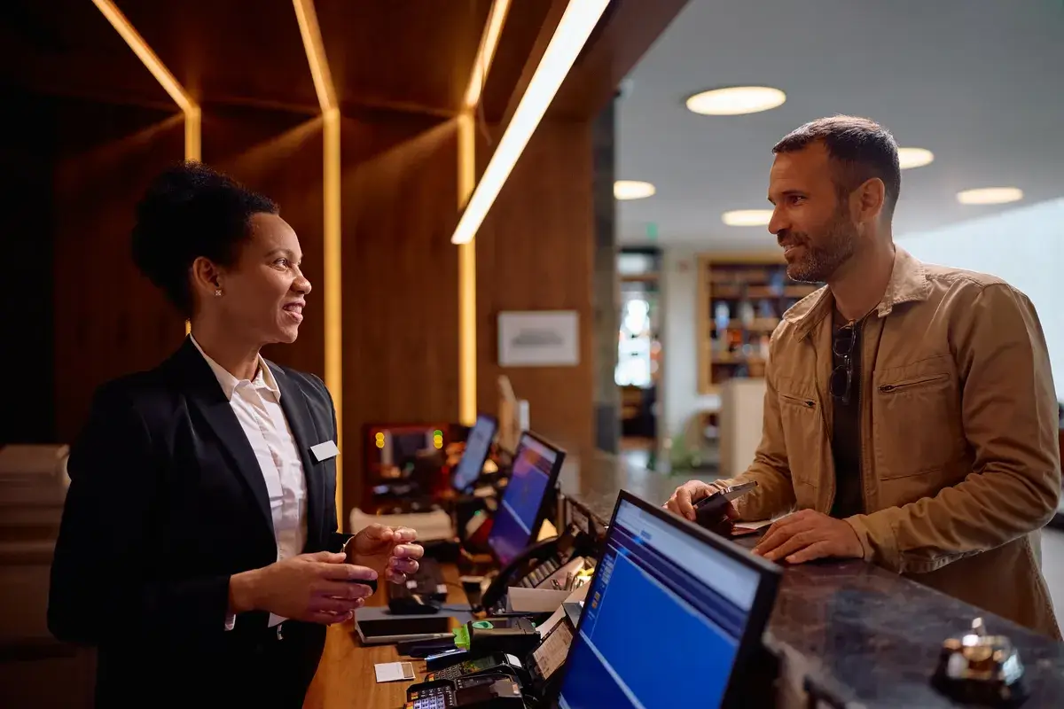 happy-guest-talking-to-black-female