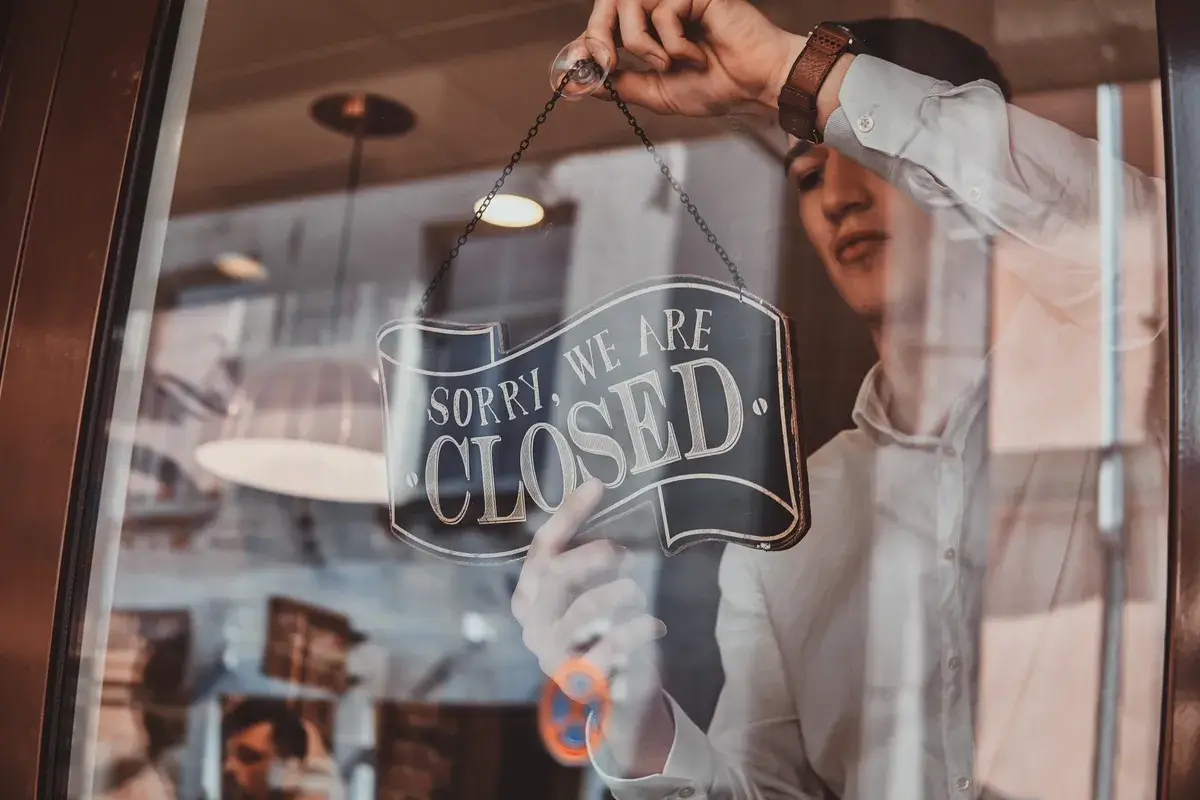 man-in-shirt-is-putting-nameplate-about-closing