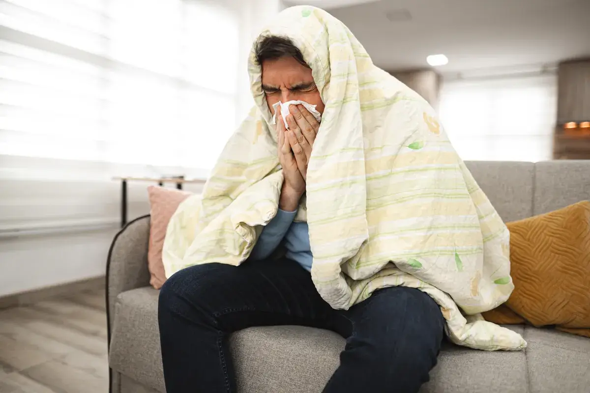 sick-man-covered-with-a-blanket-sits
