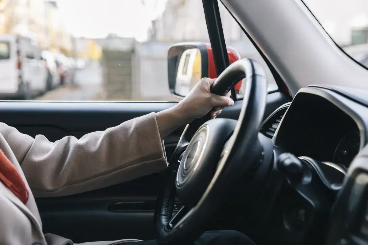 unrecognizable-person-driving-car-in-the-city