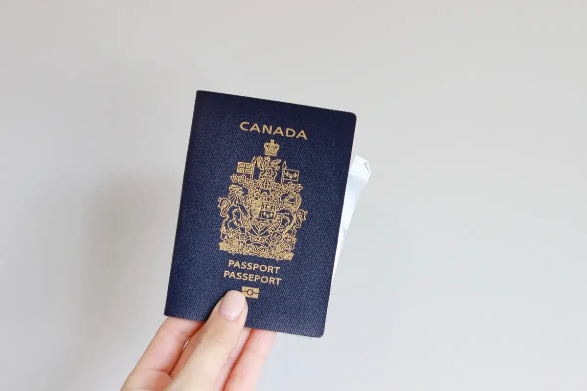woman-s-hand-holding-a-canadian-passport