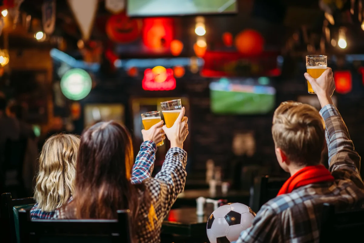 group-of-football-fans-watching-match-in-sport-bar
