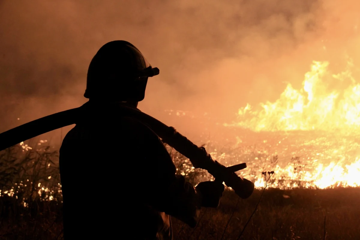 firefighter-silhouetted-against-flames-during