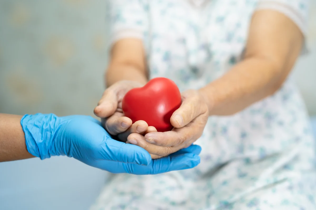 hands-holding-heart-object-in-health-care-setting