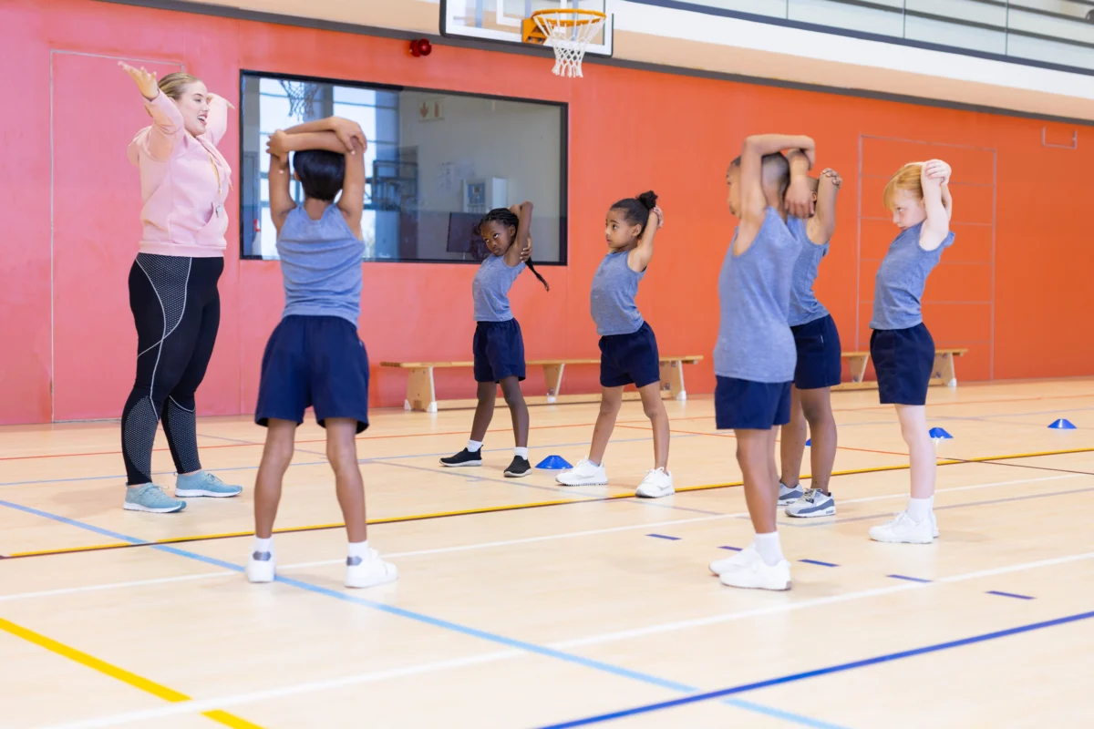 in-school-gym-female-teacher-leading.webp