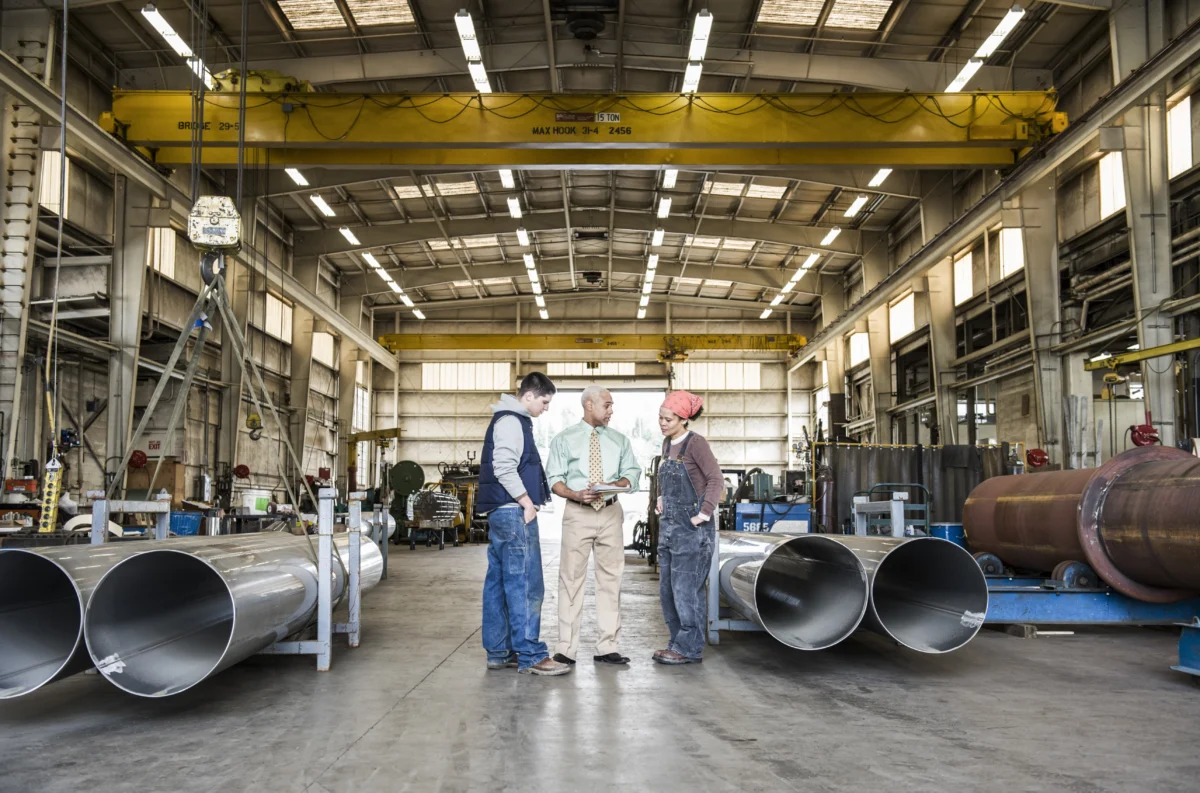 employees-discussing-project-in-industrial-factory